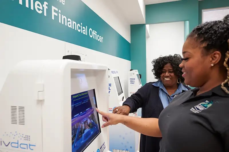 woman using a bill pay kiosk