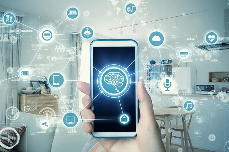 hand holding a mobile phone with a bran in the center, connecting to other various icons