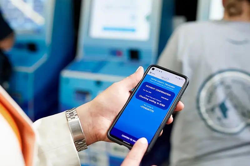 person using a phone to pay a bill